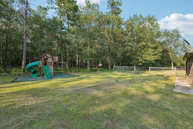 view of yard with fence and playground community