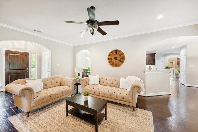living room with crown molding, visible vents, dark wood-style flooring, recessed lighting, and arched walkways