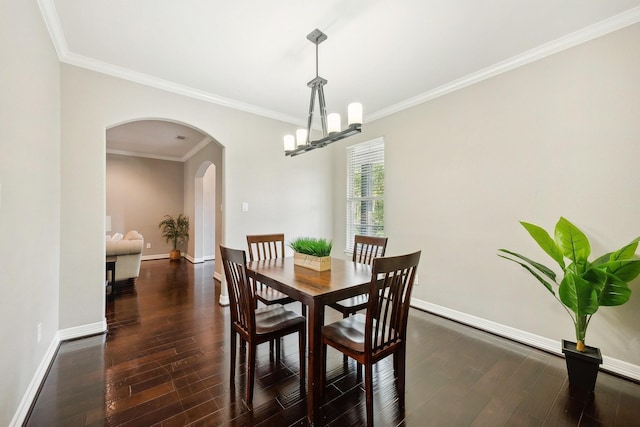 dining area with baseboards, arched walkways, a chandelier, and ornamental molding