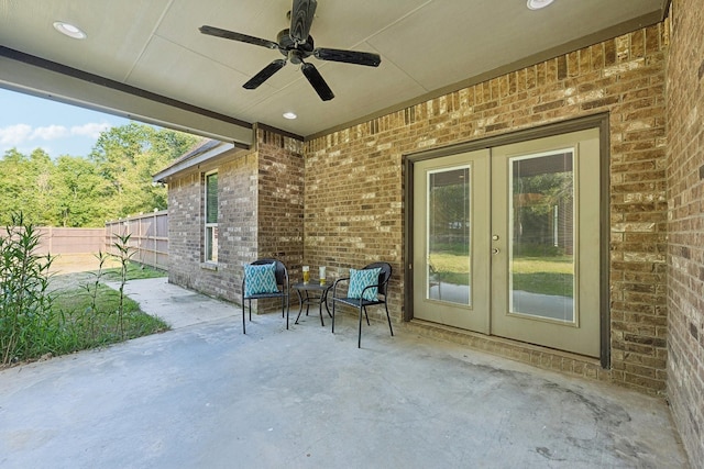 view of patio with ceiling fan, fence, and french doors