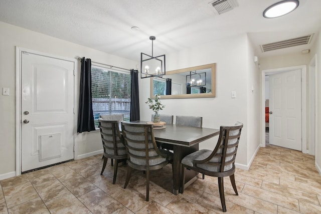 21894 Pinewilde Ct, Porter, TX 77365 - dining space featuring a chandelier, baseboards, visible vents, and a textured ceiling