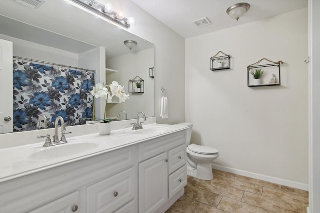 21894 Pinewilde Ct, Porter, TX 77365 - full bath with double vanity, toilet, visible vents, and a sink