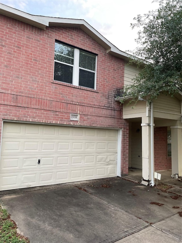 view of property exterior featuring brick siding, an attached garage, and concrete driveway