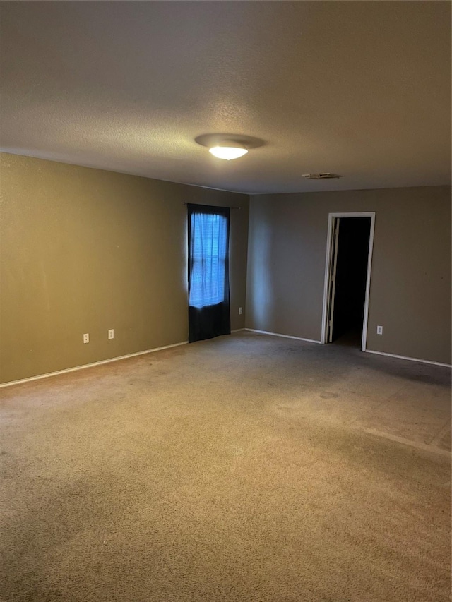 empty room with baseboards and carpet flooring