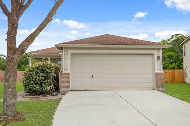 ranch-style home with fence, a front yard, brick siding, concrete driveway, and an attached garage