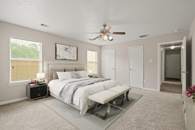 bedroom with visible vents, carpet, and baseboards