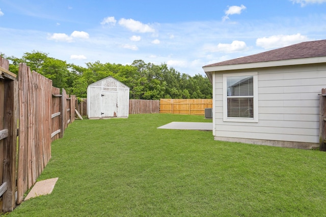 view of yard featuring a fenced backyard, an outbuilding, a patio area, and a storage shed