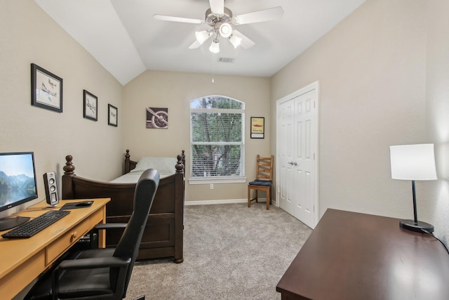 home office with vaulted ceiling, light carpet, a ceiling fan, and visible vents