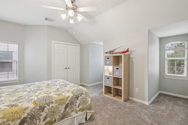bedroom featuring carpet floors, baseboards, lofted ceiling, and a closet