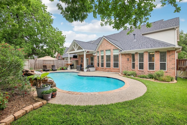 view of pool with a lawn, a fenced backyard, a patio area, and a fenced in pool