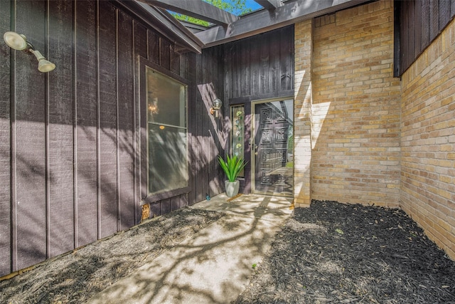 view of side of property featuring brick siding