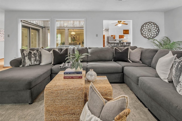living room with ceiling fan and light carpet