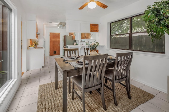 dining space with ceiling fan and light tile patterned floors