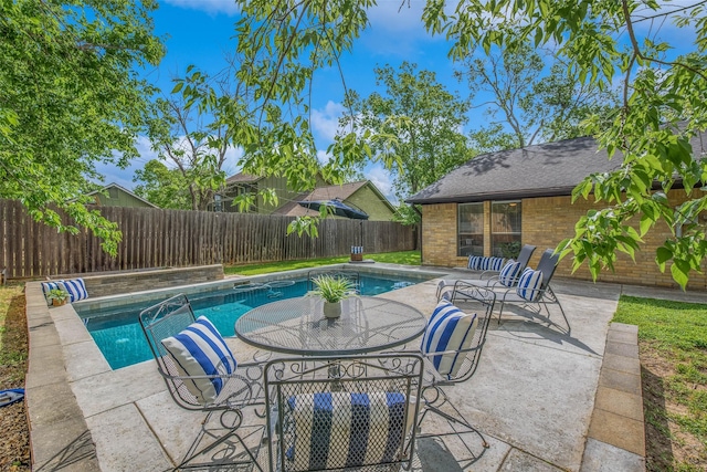 view of swimming pool featuring a fenced in pool, a fenced backyard, and a patio area
