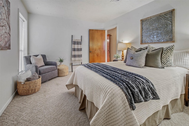 carpeted bedroom featuring baseboards and visible vents