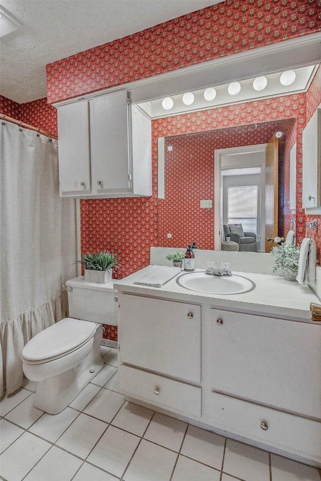 full bath with vanity, tile patterned floors, toilet, and wallpapered walls