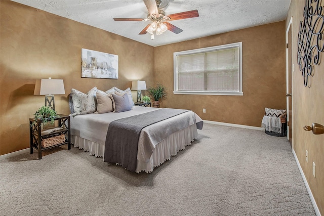 carpeted bedroom with baseboards, a textured ceiling, and ceiling fan