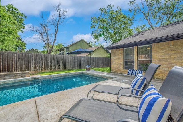 view of swimming pool featuring a fenced backyard, a fenced in pool, and a patio area