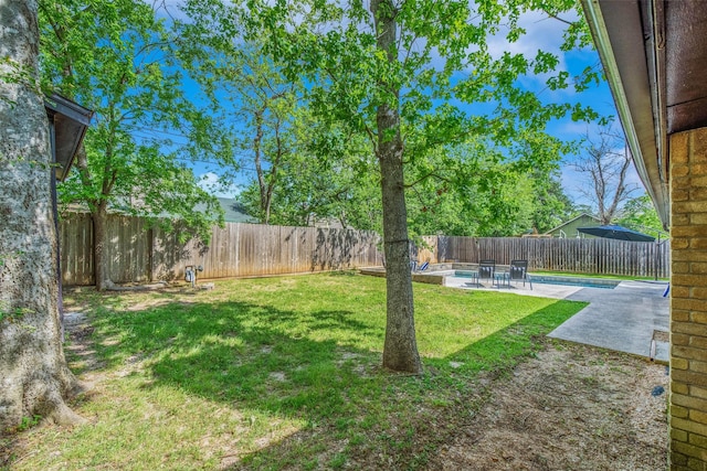 view of yard featuring a fenced in pool, a fenced backyard, and a patio area