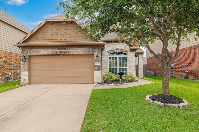 view of front of house with driveway, a front lawn, stone siding, and a garage