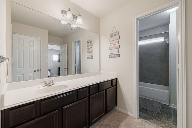 bathroom featuring baseboards, vanity, and toilet