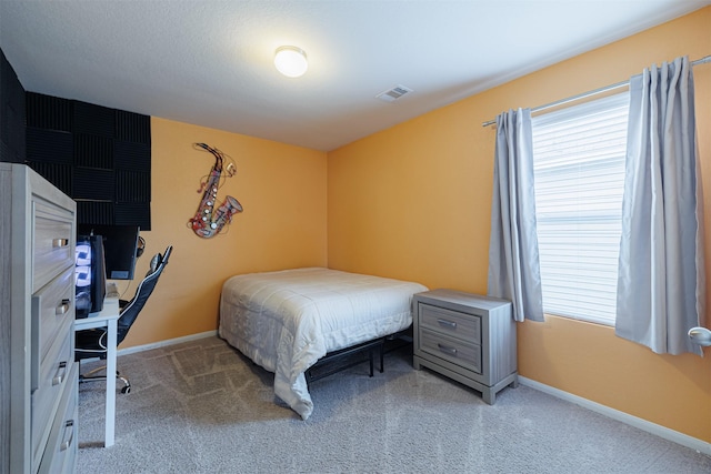 bedroom with carpet floors, baseboards, and visible vents