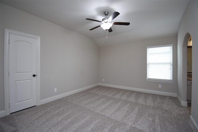 19019 Kimber Creek Ln, Cypress, TX 77429 - empty room featuring carpet flooring, ceiling fan, baseboards, vaulted ceiling, and arched walkways