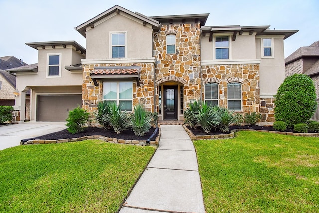 19019 Kimber Creek Ln, Cypress, TX 77429 - view of front facade featuring stone siding, stucco siding, and concrete driveway