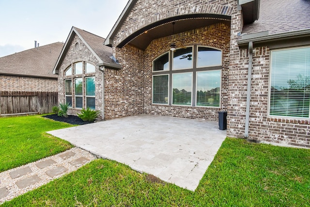 19019 Kimber Creek Ln, Cypress, TX 77429 - property entrance with a ceiling fan, a patio, brick siding, and a shingled roof