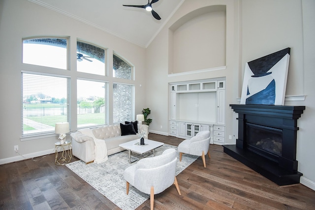 19019 Kimber Creek Ln, Cypress, TX 77429 - living area featuring a ceiling fan, high vaulted ceiling, crown molding, a glass covered fireplace, and baseboards