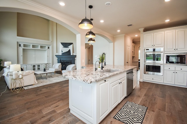19019 Kimber Creek Ln, Cypress, TX 77429 - kitchen featuring stainless steel appliances, a sink, white cabinetry, light stone countertops, and crown molding