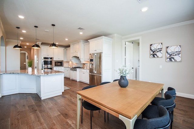 19019 Kimber Creek Ln, Cypress, TX 77429 - dining space with arched walkways, ornamental molding, dark wood-type flooring, recessed lighting, and baseboards