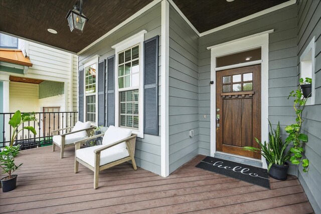 view of exterior entry with covered porch