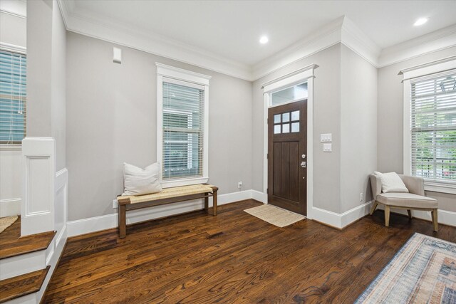 foyer entrance with dark wood-type flooring, recessed lighting, baseboards, and crown molding