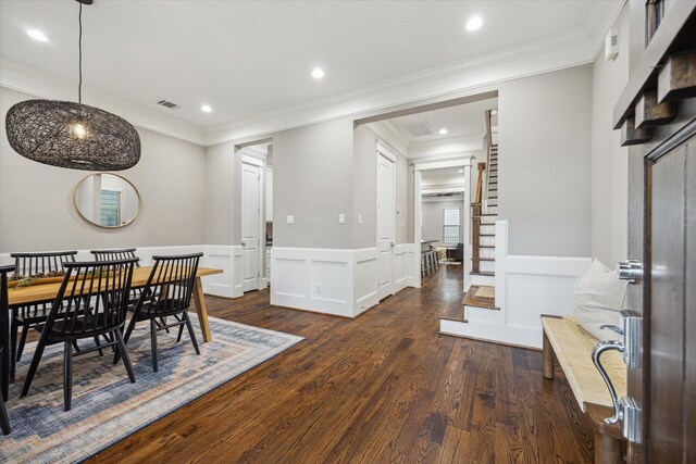 dining space featuring visible vents, ornamental molding, dark wood-style floors, recessed lighting, and a wainscoted wall