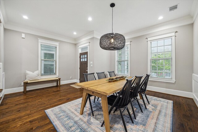 dining room featuring visible vents, crown molding, wood finished floors, baseboards, and recessed lighting