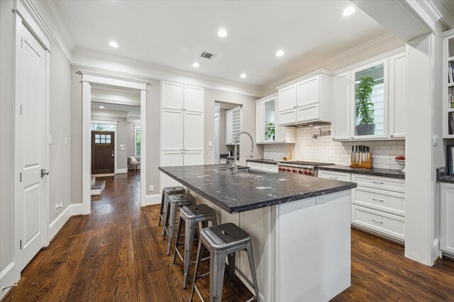 kitchen featuring a sink, ornamental molding, backsplash, and visible vents