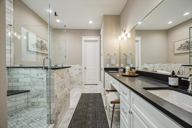 full bathroom featuring a sink, a stall shower, recessed lighting, and marble finish floor
