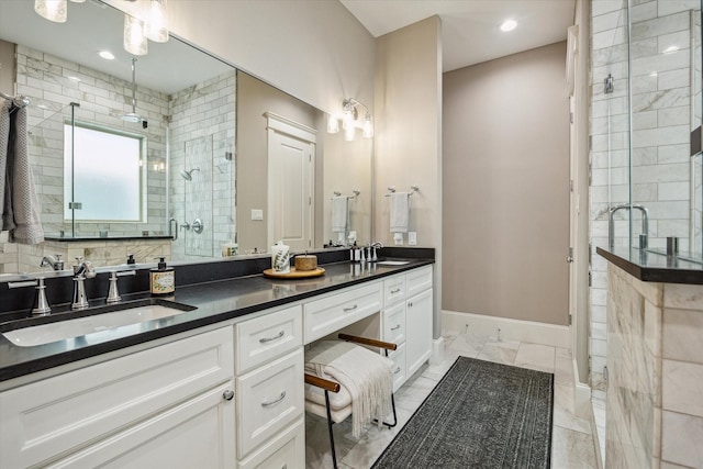 bathroom with double vanity, a sink, marble finish floor, and a stall shower