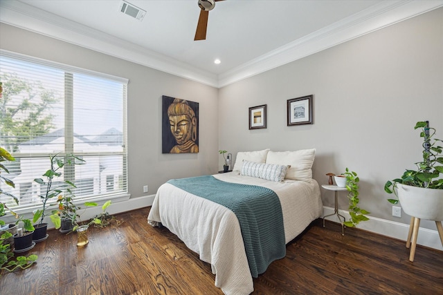 bedroom featuring baseboards, visible vents, ornamental molding, and wood finished floors
