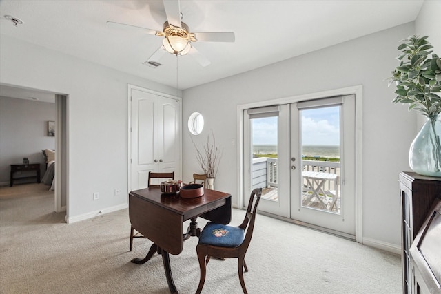 office space featuring visible vents, light carpet, baseboards, french doors, and a ceiling fan