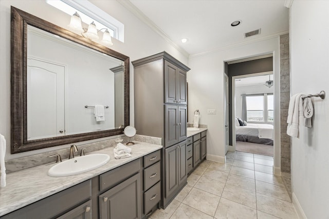 ensuite bathroom with visible vents, ornamental molding, vanity, baseboards, and ensuite bathroom