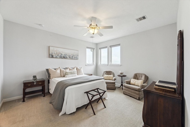 bedroom featuring baseboards, ceiling fan, light carpet, and visible vents