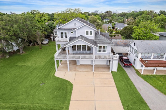 exterior space featuring concrete driveway, a yard, a balcony, and roof with shingles