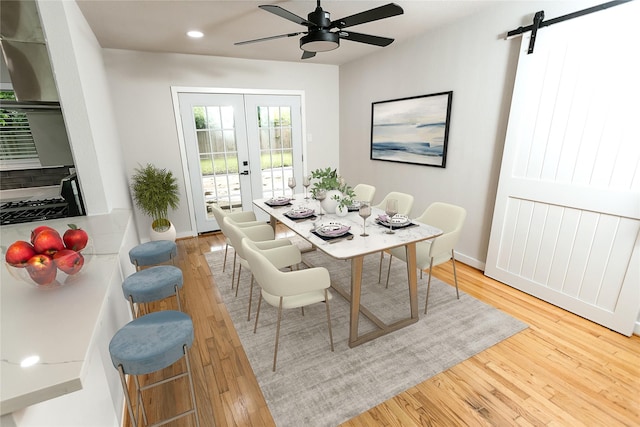 dining area with french doors, a ceiling fan, wood finished floors, a barn door, and recessed lighting
