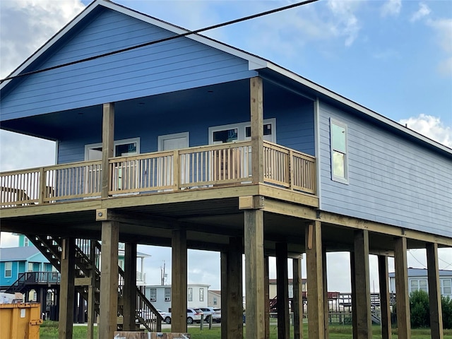 528 Thunder Rd, Surfside Beach, TX 77541 - rear view of property with stairs and a wooden deck
