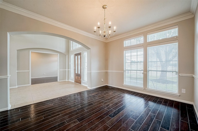 17931 Oakfield Glen Ln, Cypress, TX 77433 - unfurnished room featuring crown molding, arched walkways, a chandelier, baseboards, and wood finished floors