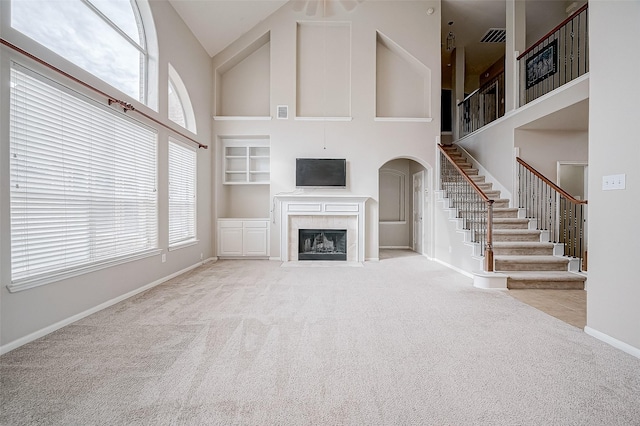 17931 Oakfield Glen Ln, Cypress, TX 77433 - unfurnished living room with carpet flooring, a towering ceiling, a wealth of natural light, and stairway
