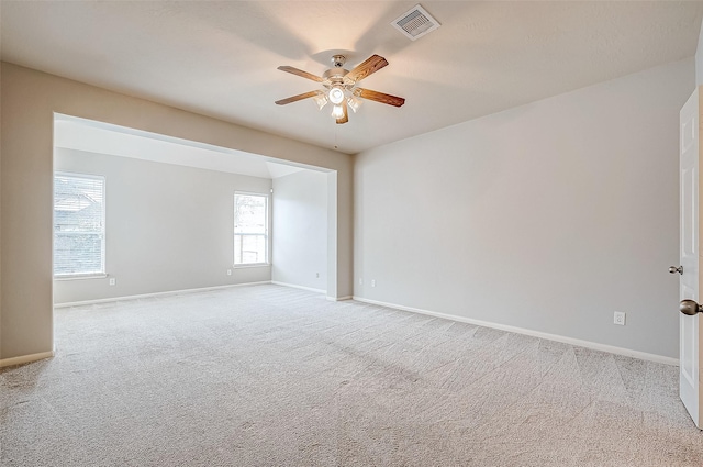 17931 Oakfield Glen Ln, Cypress, TX 77433 - empty room featuring a ceiling fan, baseboards, visible vents, and light carpet