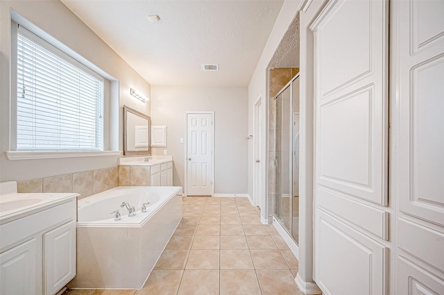 17931 Oakfield Glen Ln, Cypress, TX 77433 - bathroom with tile patterned flooring, a garden tub, visible vents, two vanities, and a shower stall